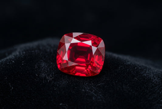 Unheated Burma Mogok ruby cushion cut pigeon blood red gemstone on black velvet