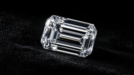 Macro photograph of an emerald-cut diamond on black velvet under dramatic lighting