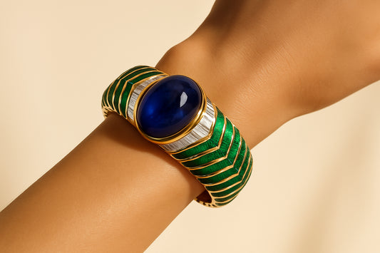 Bulgari sapphire emerald diamond bangle worn on wrist — authentication guide by Spectra Fine Jewelry