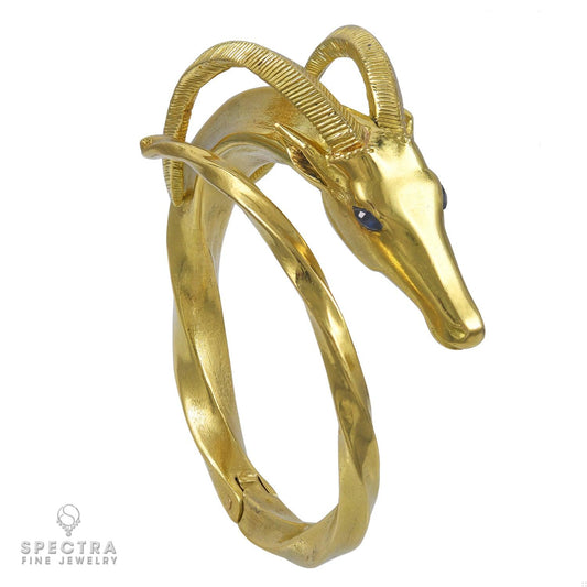 Hermès Vintage 18K Gold Capricorn Bangle with Sapphire Eyes